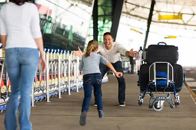 A happy family reuniting at a Canadian airport after successful Super Visa approval.