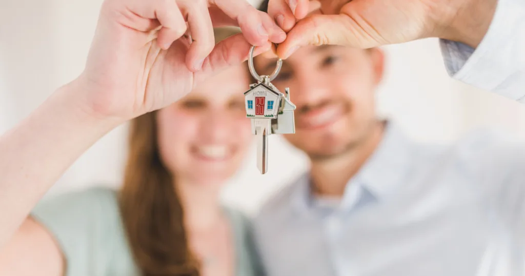A happy Cornwall family holding house keys after following the steps to mortgage approval and becoming mortgage-ready.